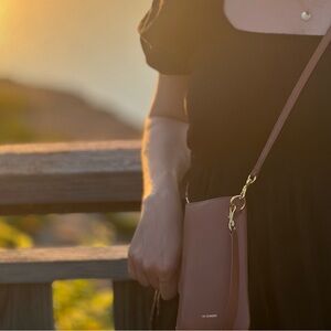 Jill Sander bag. It will hold phone, credit cards and lipstick etc.